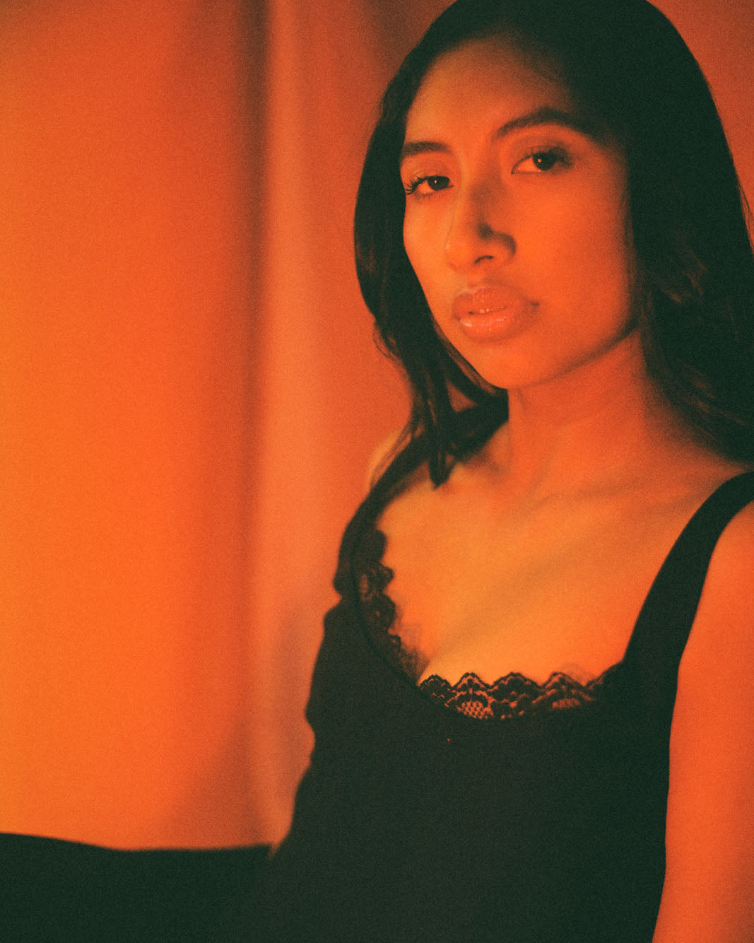 Close up of black corset top with lace trim and ribbon ties, handcrafted in cotton by Mariana by Alba