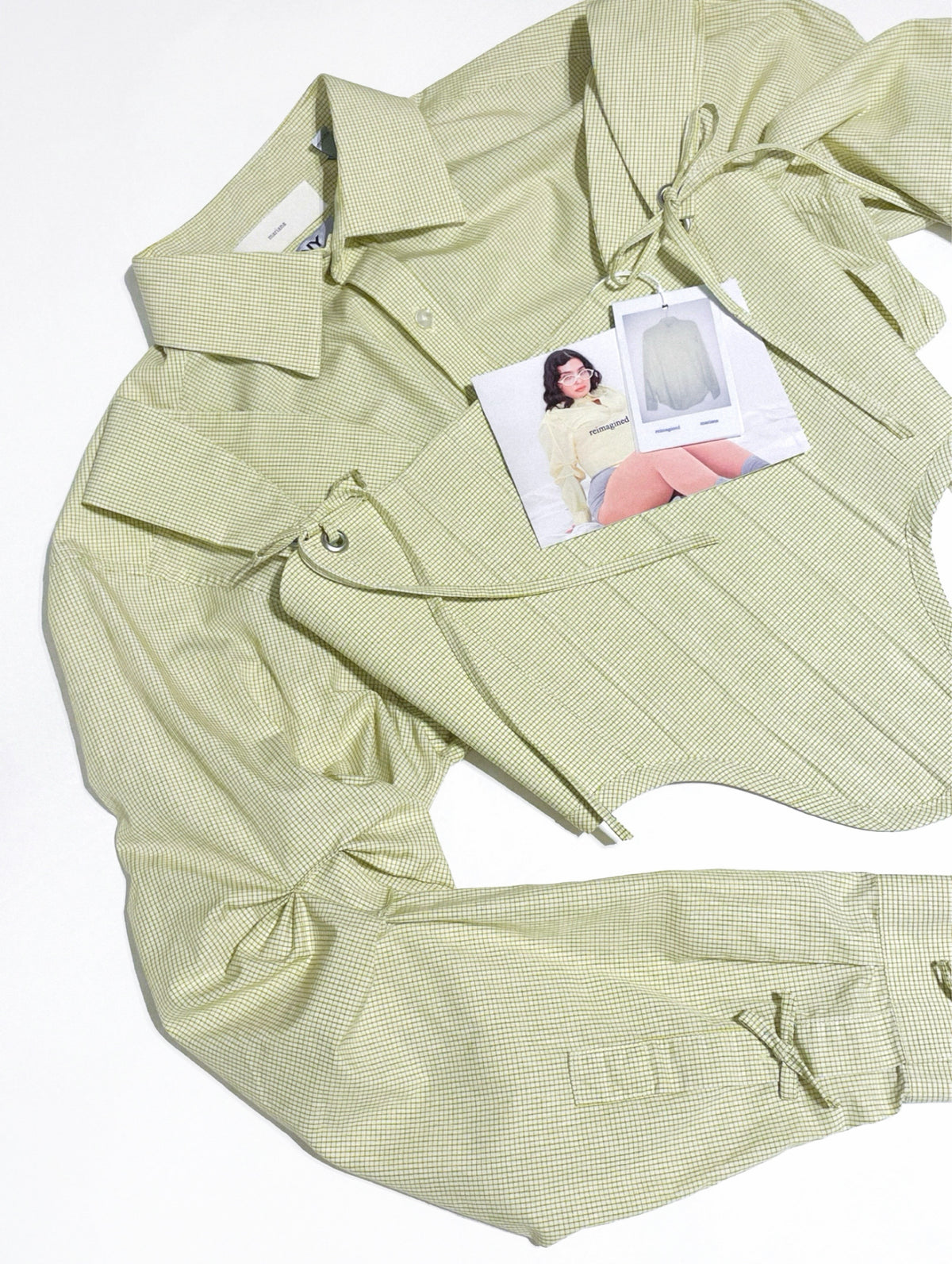Light green checkered shirt with a model photo tag on a white background